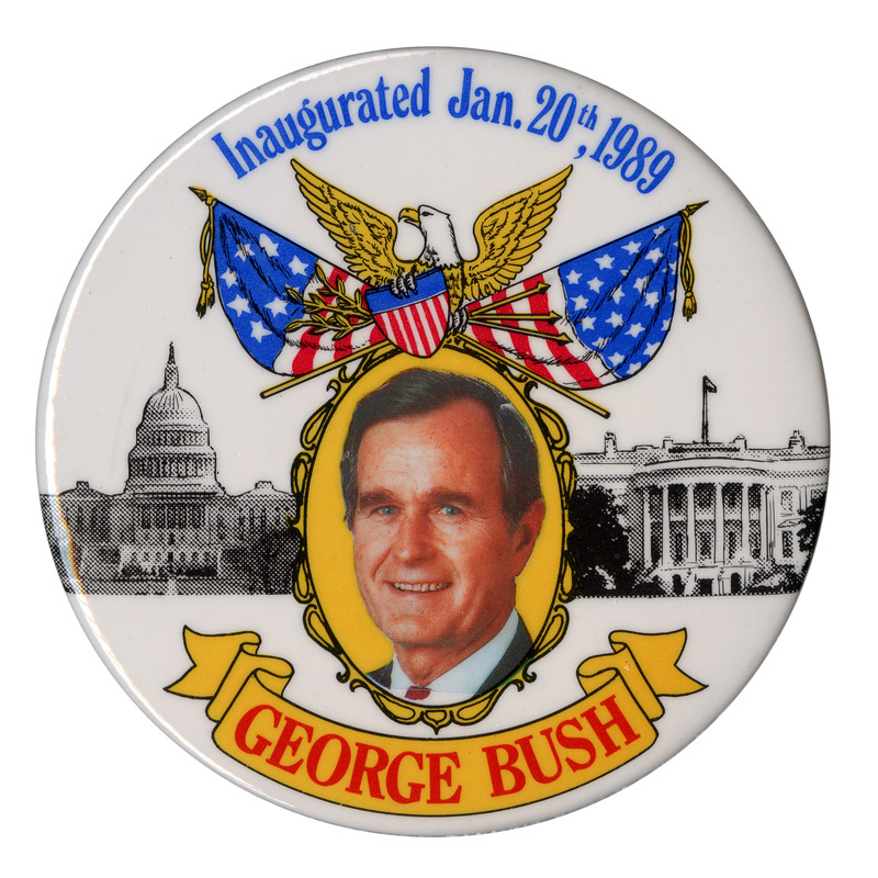 Round, white button with a color photograph of George H. W. Bush against black and white photographs of the US Capitol and the White House, topped by a color drawing of an eagle holding a shield, olive branches, and spears in front of two US flags. Blue and red text reads "Inaugurated Jan. 20th, 1989 GEORGE BUSH"