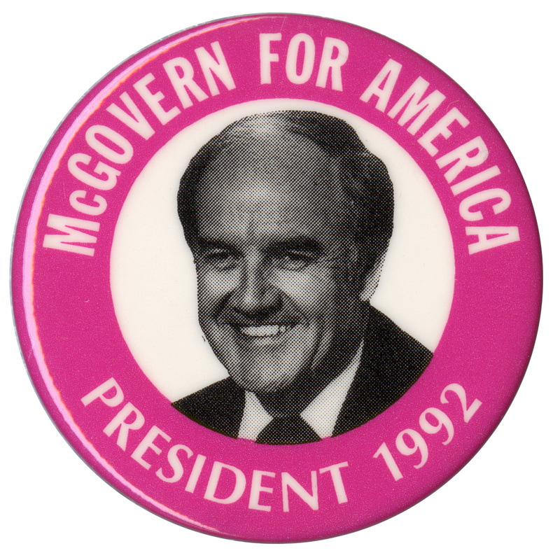 Round button with a pink border and a black and white photograph of George McGovern in a white circle in the center. White text around the edge reads "McGOVERN FOR AMERICA PRESIDENT 1992"