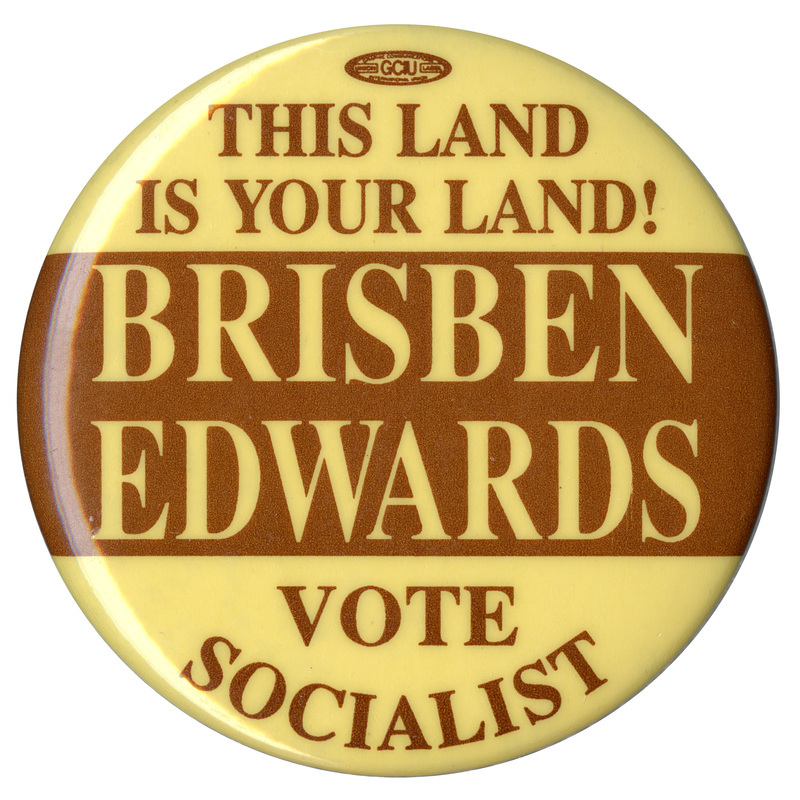 Round, yellow and brown button with contrasting brown and yellow text reading "THIS LAND IS YOUR LAND! BRISBEN EDWARDS VOTE SOCIALIST"