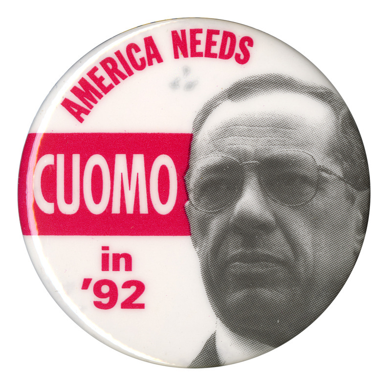 Round, white button with a black and white photograph of Mario Cuomo and a red band across the middle. Red and white text reads  "AMERICA NEEDS CUOMO in '92"