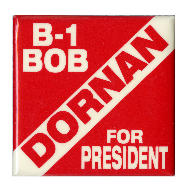 Square, red and white button with contrasting white and red text reading "B-1 BOB DORNAN FOR PRESIDENT" 