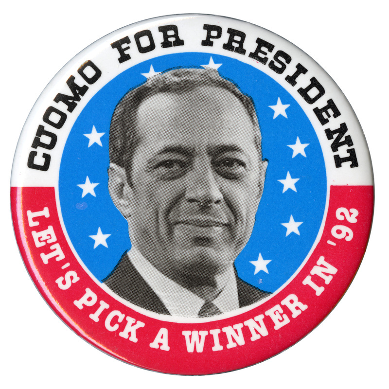 Round button with a white and red border and a black and white photograph of Mario Cuomo surrounded white stars on a blue field. Black and white text reads "CUOMO FOR PRESIDENT LET'S PICK A WINNER IN '92" 