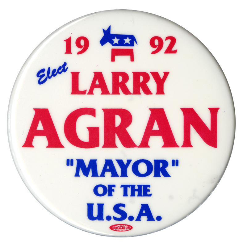 Round, white button with blue and red text reading "1992 Elect LARRY AGRAN "MAYOR" OF THE U.S.A." and a picture of the Democratic Party donkey symbol.