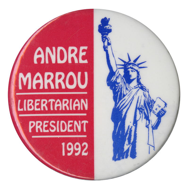 Round button with a red left half with white text reading "ANDRE MARROU LIBERTARIAN PRESIDENT 1992." The right half is white and contains a blue drawing of the Statue of Liberty.