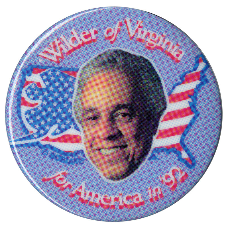 Round, blue button with a color photograph of Lawrence Douglas Wilder against an outline of the United States filled with the red, white, and blue stars and stripes of the US flag. White and red text reads "Wilder of Virginia for America in '92"
