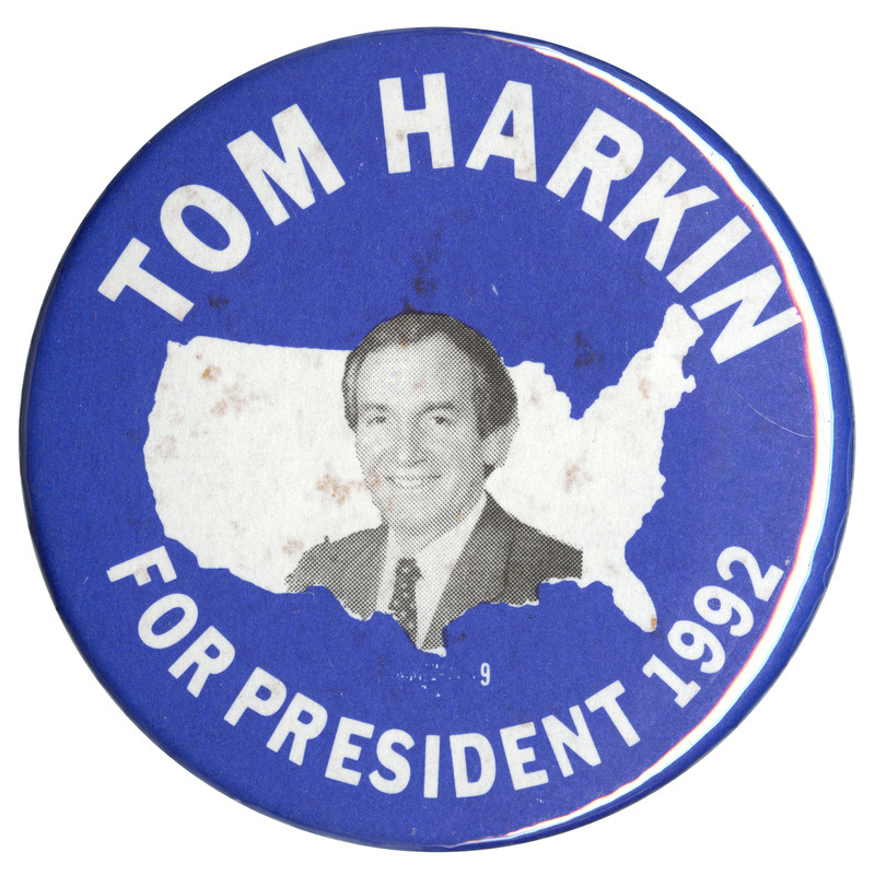 Round, blue button with a black and white photograph of Tom Harkin against a white outline of the United States. White text reads "TOM HARKIN FOR PRESIDENT 1992"