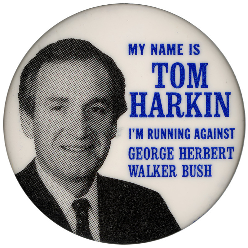 Round, white button with a black and white photograph of Tom Harkin. Blue text reads "MY NAME IS TOM HARKIN I'M RUNNING AGAINST GEORGE HERBERT WALKER BUSH"