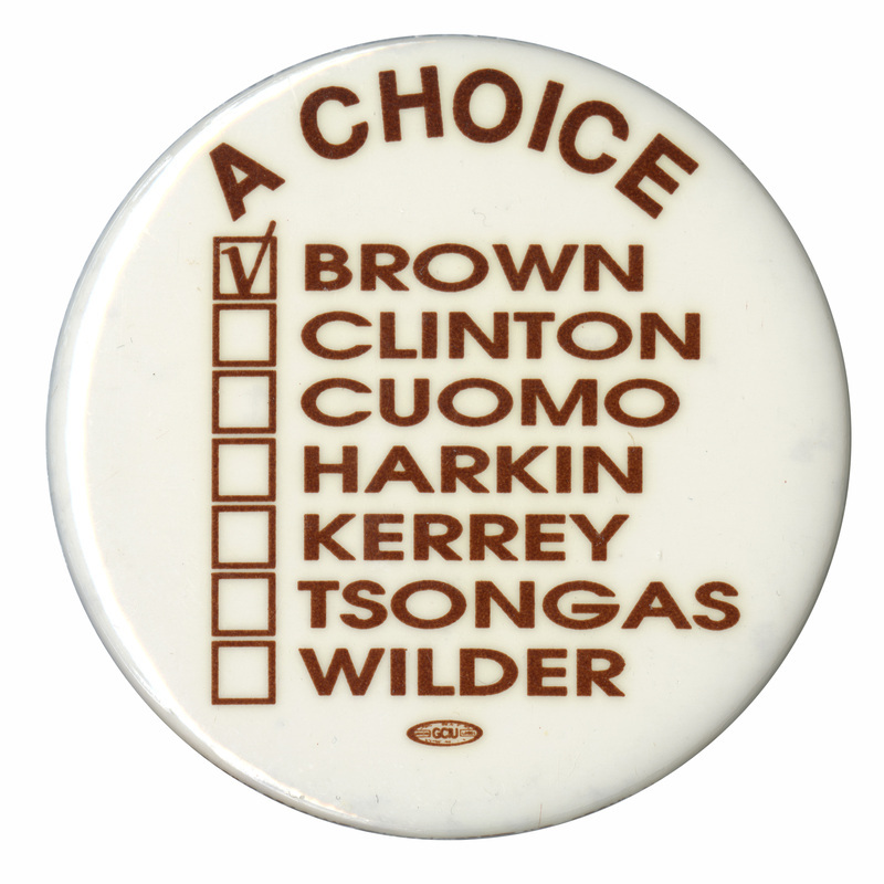 Round, white button with black text reading "A CHOICE", below which is a vertical list of names, each with a box to its left. In black text, the names read "BROWN CLINTON CUOMO HARKIN KERREY TSONGAS WILDER." The box next to Brown's name is checked.