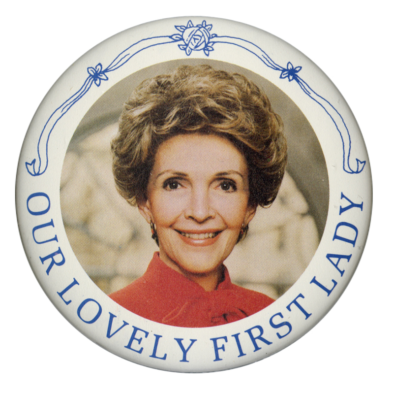 Round button bordered in white with a color photograph of Nancy Reagan in the center. Blue text reads "OUR LOVELY FIRST LADY"