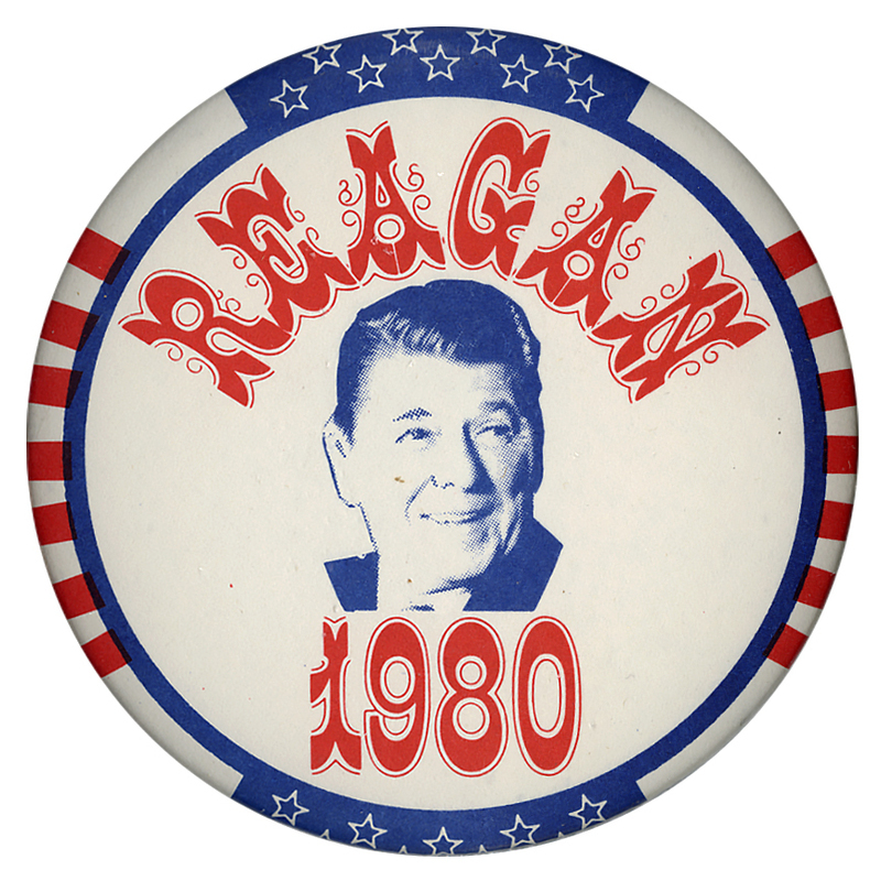 Round button bordered in red, white, and blue stars and stripes. In the center is a photograph of Ronald Reagan surrounded by elaborate red text reading "REAGAN 1980"