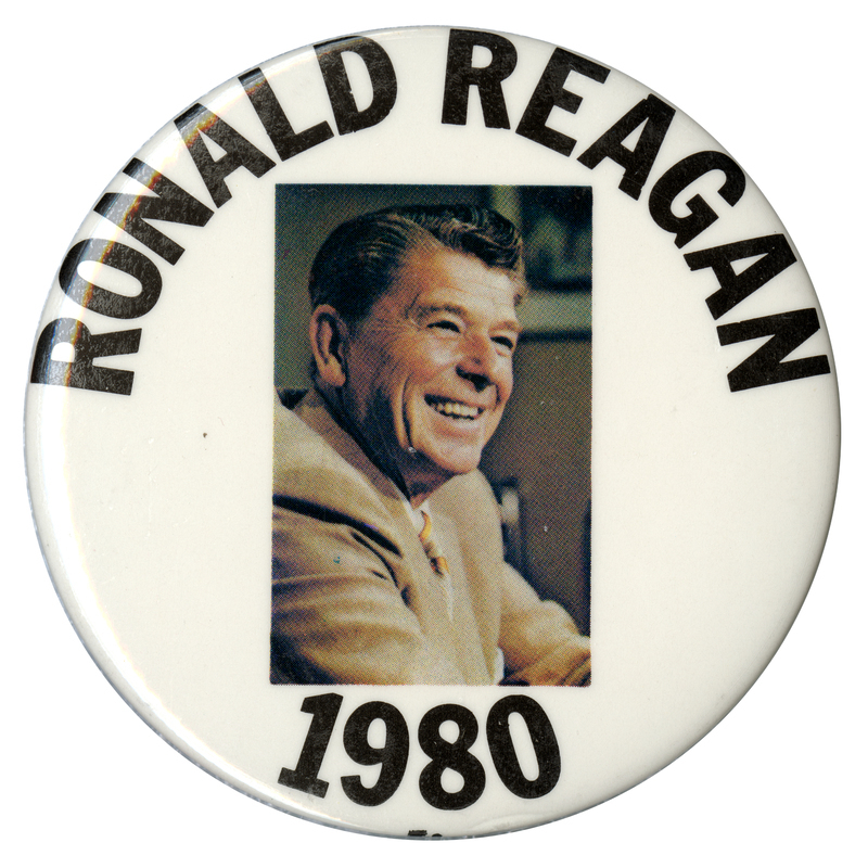 Round, white button with a rectangular color photograph of Ronald Reagan. Black text reads "RONALD REAGAN 1980"
