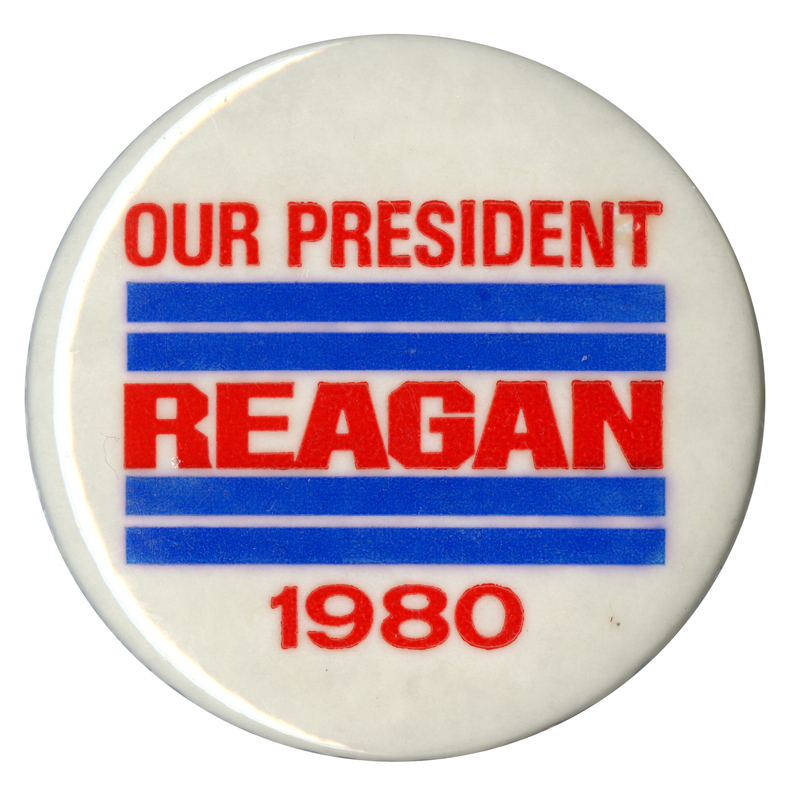 Round, white button with thick blue stripes. Red text reads "OUR PRESIDENT REAGAN 1980"