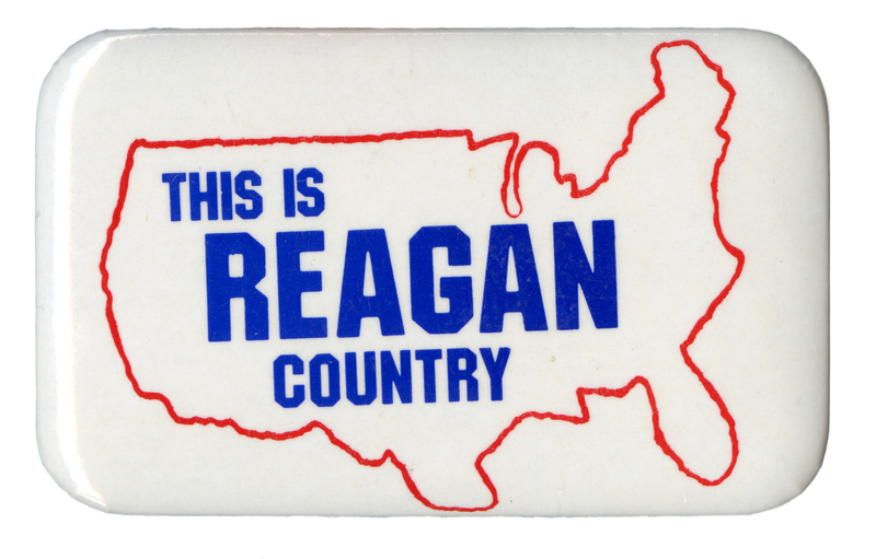 Rectangular, white button with a red outline of the United States and blue text reading "THIS IS REAGAN COUNTRY"