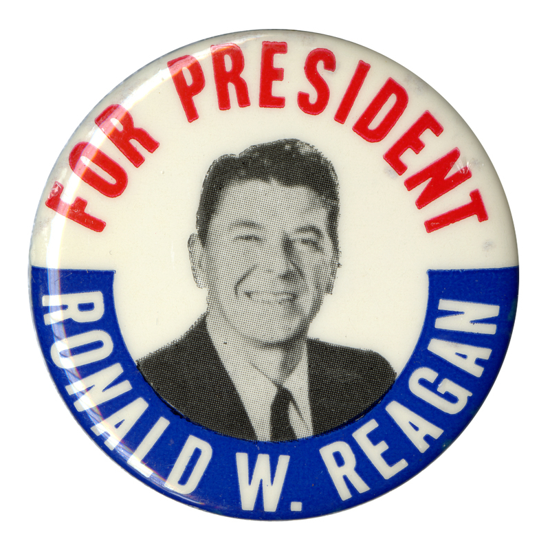 Round, white button with a black and white photograph of Ronald Reagan. Red and white text reads "FOR PRESIDENT RONALD W. REAGAN"