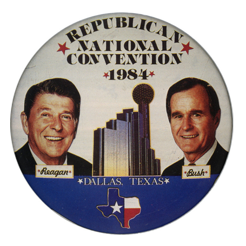 Round button with color photographs of Ronald Reagan and George H. W. Bush on either side of a color photograph of the Hyatt Regency Hotel and Reunion Tower in Dallas, Texas. An outline of the state of Texas filled with the Texas state flag design appears below. Black and white text reads "REPUBLICAN NATIONAL CONVENTION 1984 Reagan Bush DALLAS, TEXAS"