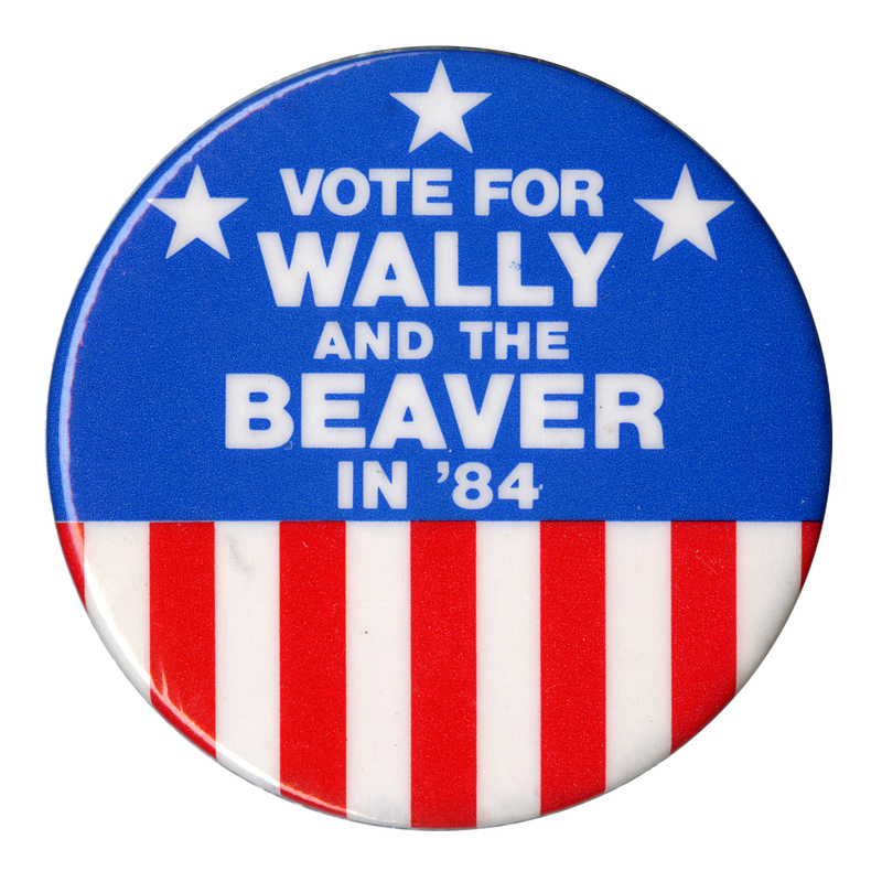 Round button, blue with stars on the upper half and red and white stripes on the lower half. White text reads "VOTE FOR WALLY AND THE BEAVER IN '84"