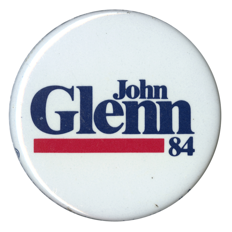 Round, white button with black text reading "John Glenn 84"