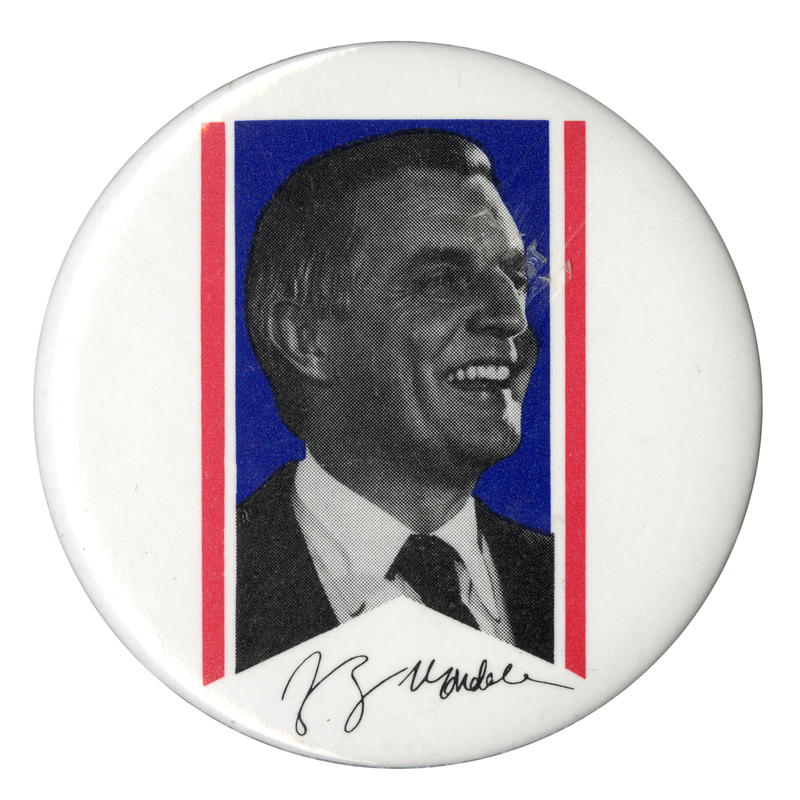 Round, white button with a black and white photograph of Walter Mondale inside of a blue and white ribbon shape. Mondale's signature appears below the ribbon in black.