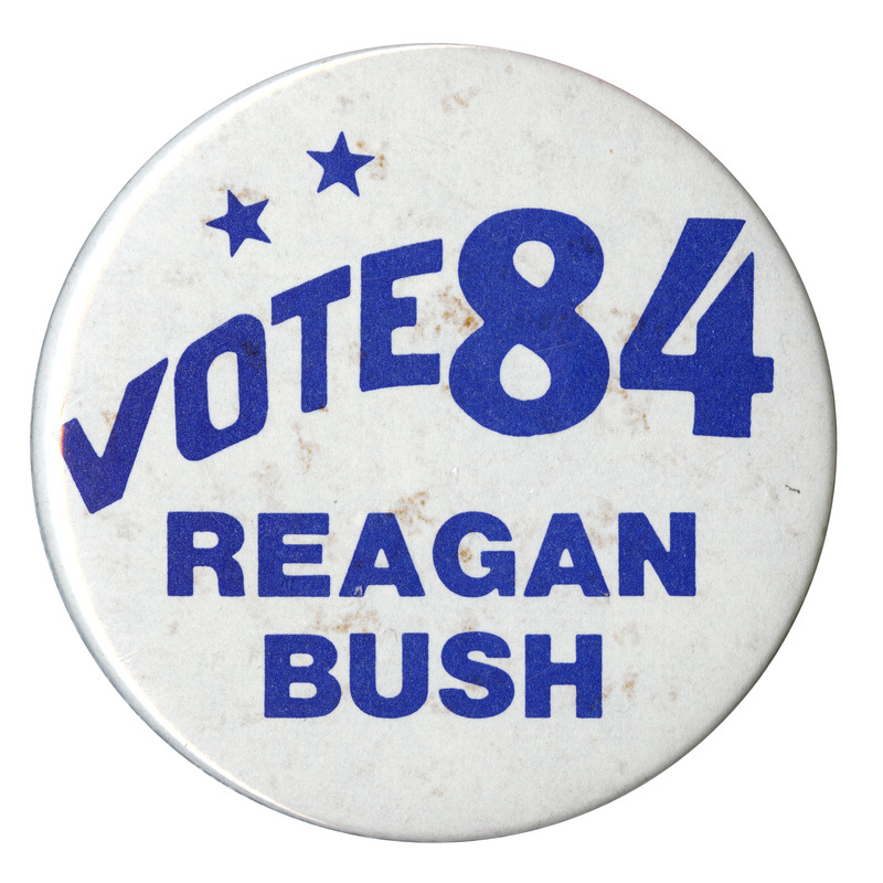 Round, white button with blue text reading "VOTE 84 REAGAN BUSH"