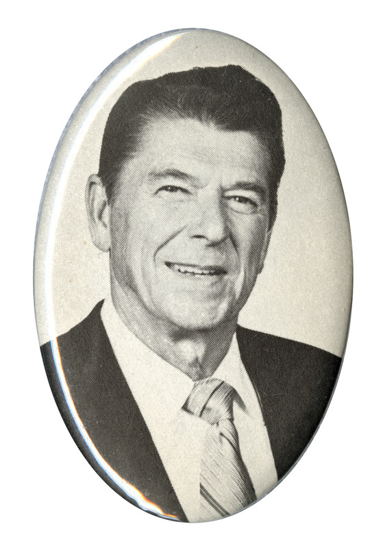 Oval button with a black and white photograph of Ronald Reagan.