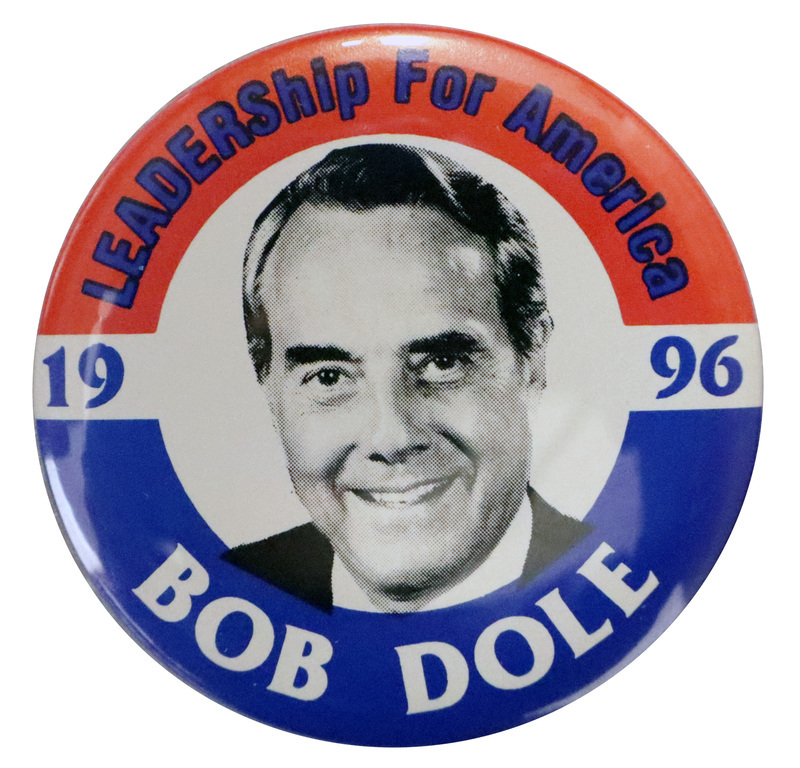 Round button with red and blue bands along the border. In the center is a black and white photograph of Bob Dole. Blue and white text reads "LEADERShip For America BOB DOLE"