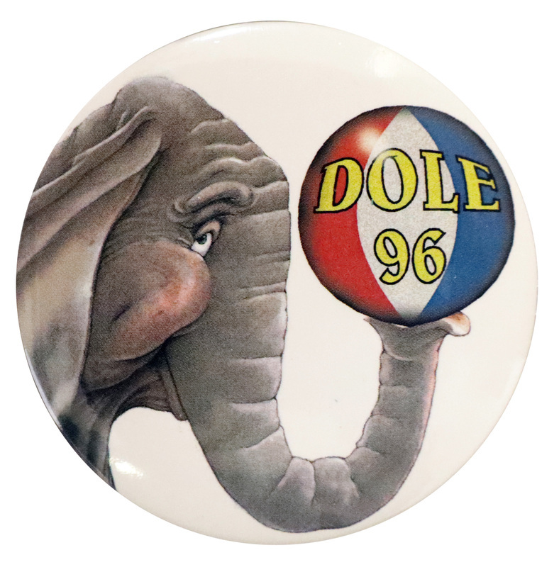 Round, white button with a color illustration of an elephant holding a red, white, and blue ball with its trunk. Yellow text on the ball reads "DOLE 96"