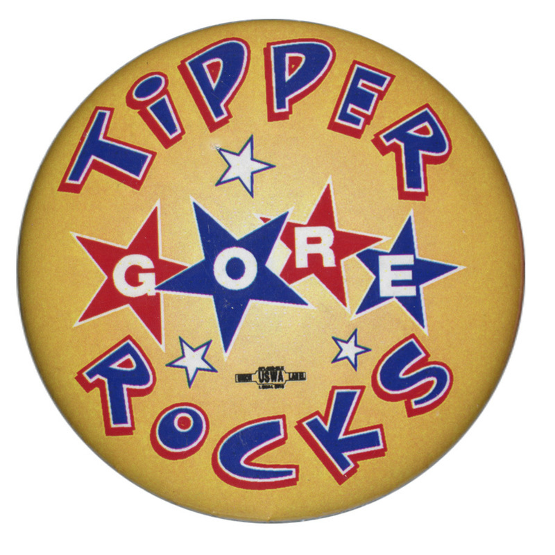 Round, yellow button with blue and white text reading "TIPPER GORE ROCKS". "GORE" is set on four red and blue stars.
