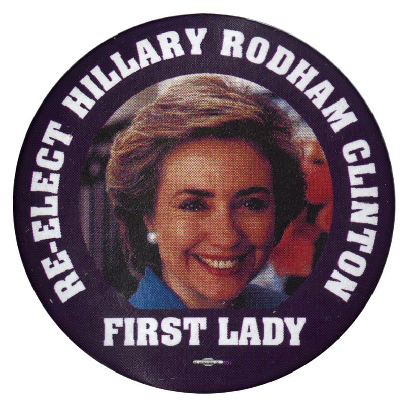 Round button with a black border around a color photograph of Hillary Clinton. White text reads "RE-ELECT HILLARY RODHAM CLINTON FIRST LADY"