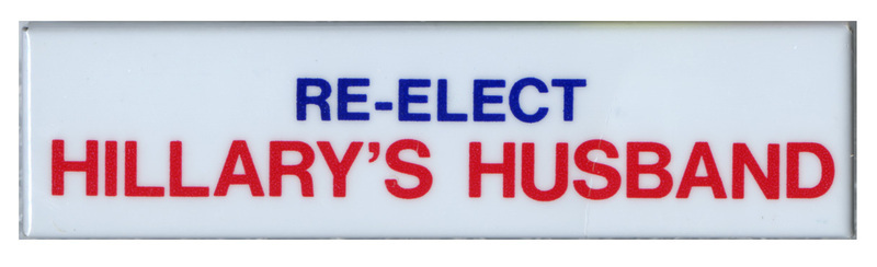 Rectangular, white button with blue and red text reading "RE-ELECT HILLARY's HUSBAND"
