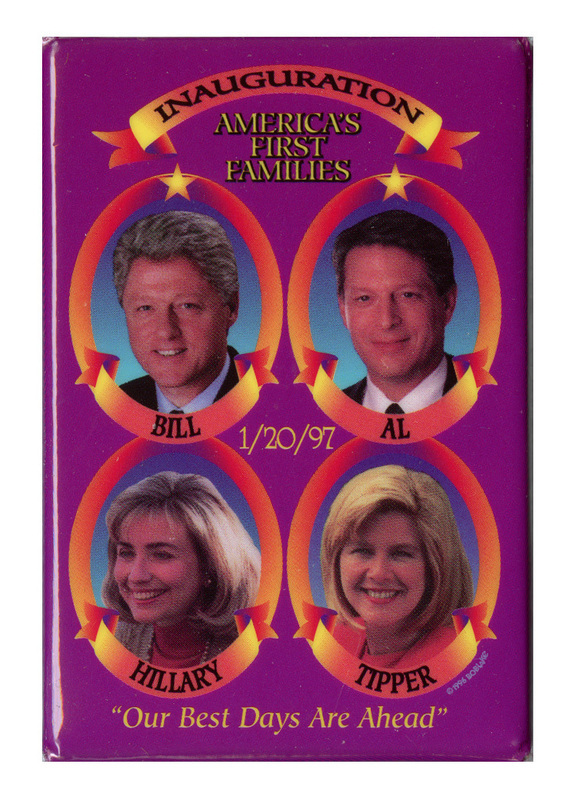 Rectangular, purple button with color photographs of Bill Clinton, Al Gore, Hillary Clinton, and Tipper Gore in yellow-to-red gradient frames. Black and yellow text reads "INAUGURATION AMERICA'S FIRST FAMILIES BILL AL HILLARY TIPPER 1/20/97 "Our Best Days Are Ahead""