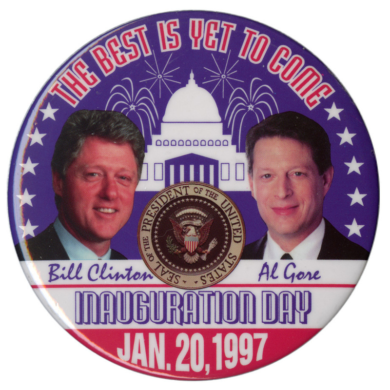 Round button with color photographs of Bill Clinton and Al Gore, the presidential seal, and a blue and white illustration of the US Capitol surrounded by fireworks explosions and white stars. Red, white, and blue text reads "THE BEST IS YET TO COME Bill Clinton Al Gore INAUGURATION DAY JAN. 20, 1997"