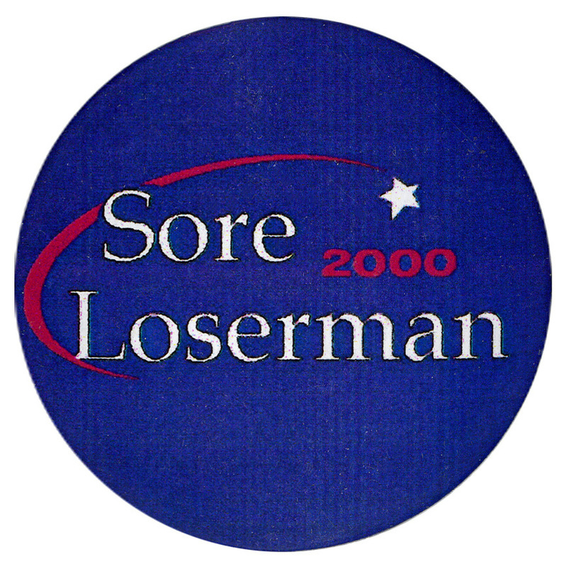 Round, blue button with white and red text reading "Sore Loserman 2000"