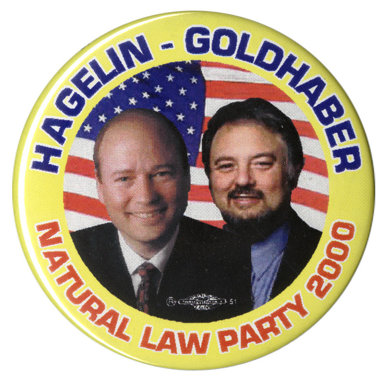Round button with a yellow outline. In the center are color photographs of John Hagelin and Nat Goldhaber against a color image of the US flag. Blue and red text reads "HAGELIN-GOLDHABER NATURAL LAW PARTY 2000"