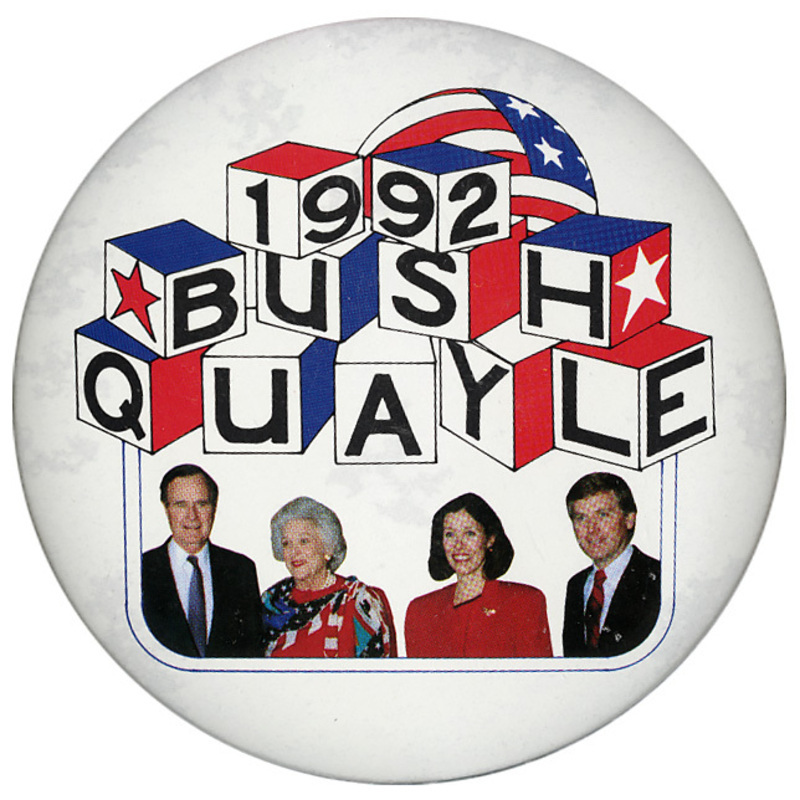 Round, white button with color photographs of George H. W. Bush, Barbara Bush, Marilyn Quayle, and Dan Quayle. Black text in red, white, and blue cubes reads "1992 BUSH QUAYLE"