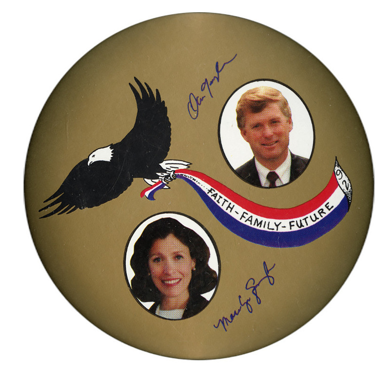Round, gold button with a drawing of an eagle carrying a red, white, and blue banner with "FAITH FAMILY FUTURE 92" written on it in black text. Color photographs of Dan Quayle and Marilyn Quayle are accompanied by their autographs.