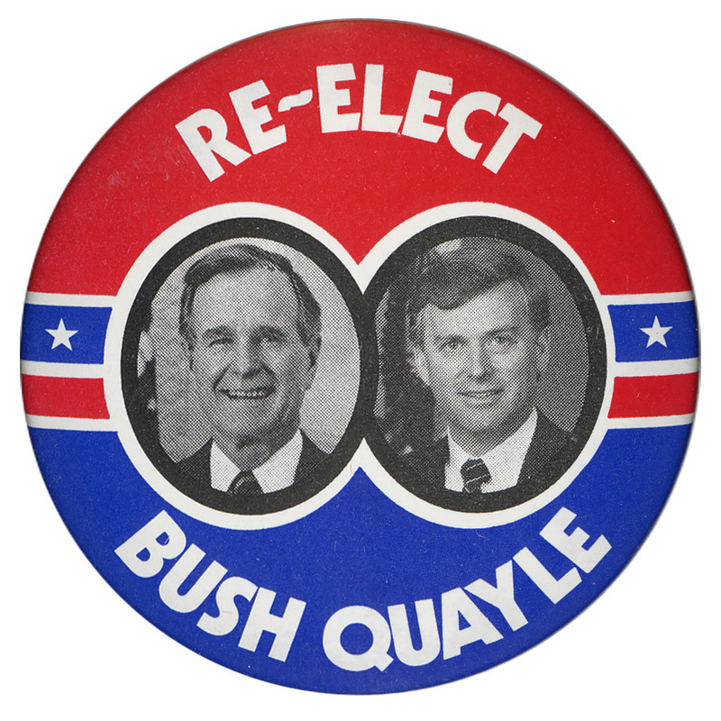 Round button with a red upper half and blue lower half and black and white photographs of George H. W. Bush and Dan Quayle in the center. White text reads "RE-ELECT BUSH QUAYLE"