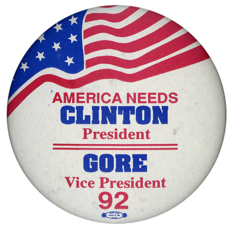 Round, white button with red, white, and blue stars and stripes in the upper half. Red and blue text reads "AMERICA NEEDS CLINTON President GORE Vice President 92"
