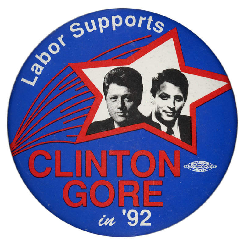 Round, blue button with a red star decoration containing a black and white photograph of Bill Clinton and Al Gore. White and red text reads "Labor Supports CLINTON GORE in '92"