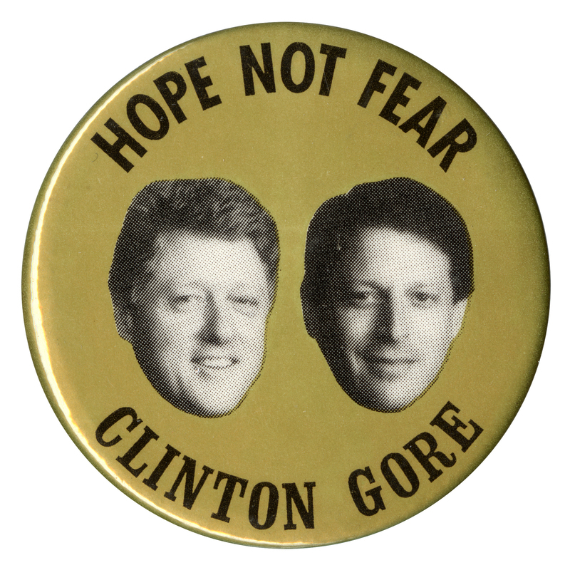 Round, gold button with black and white photographs of Bill Clinton and Al Gore. Black text reads "HOPE NOT FEAR CLINTON GORE"