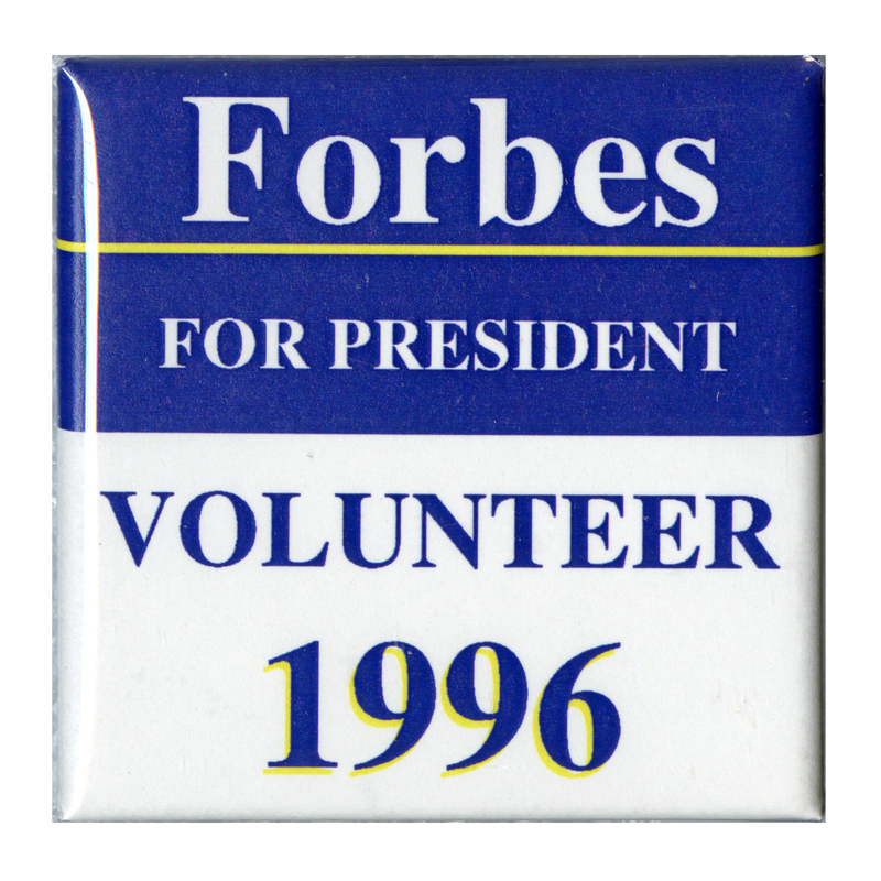 Square, blue and white button with contrasting white and blue text reading "Forbes FOR PRESIDENT VOLUNTEER 1996"