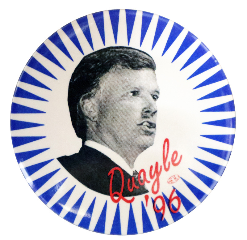 Round button with white rays against a blue background. In the center is a black and white photograph of Dan Quayle. Red text reads "Quayle '96"