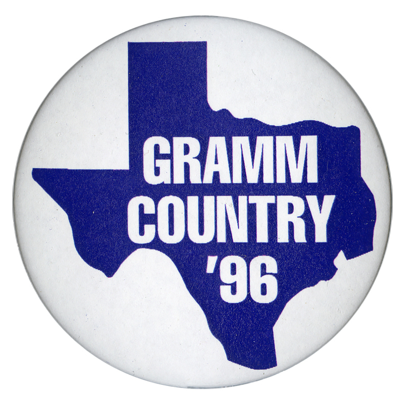 Round, white button with a blue outline of the state of Texas. White text reads "GRAMM COUNTRY '96"