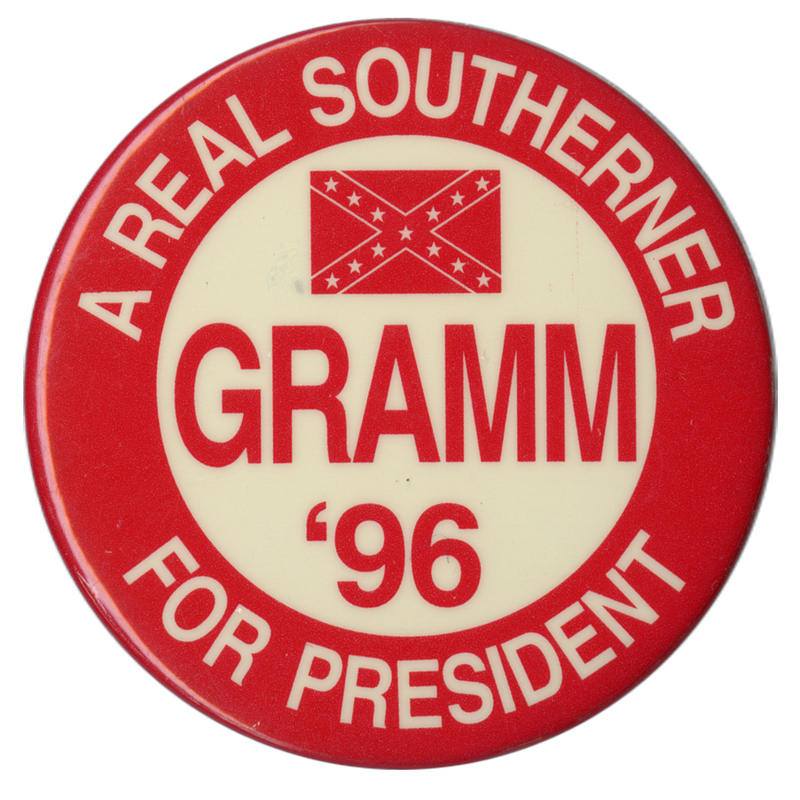 Round, red and white button with a red drawing of the Confederate flag. White and red text reads "A REAL SOUTHERNER GRAMM '96 FOR PRESIDENT"