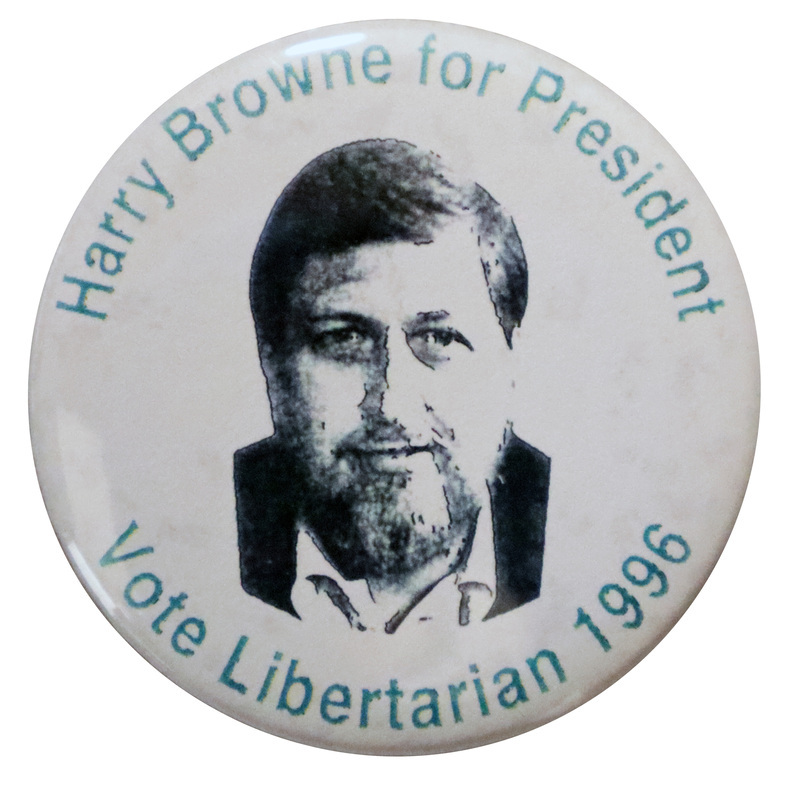 Round, white button with a black and white photograph of Harry Browne. Green text around the edge of the button reads "Harry Browne for President Vote Libertarian 1996"