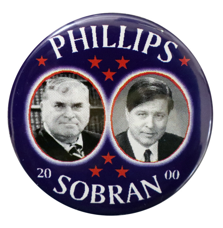 Round, blue button with black and white photographs of Howard Phillips and Michael Joseph Sobran in red-outlined circles. White text reads "PHILLIPS SOBRAN 2000"