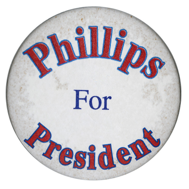 Round, white button with red and blue text reading "Phillips For President"