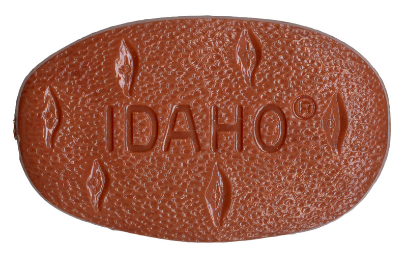 Brown, potato-shaped pin with etched text reading "IDAHO"