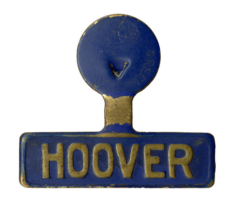 Blue, fold over lapel pin with gold text reading "HOOVER"