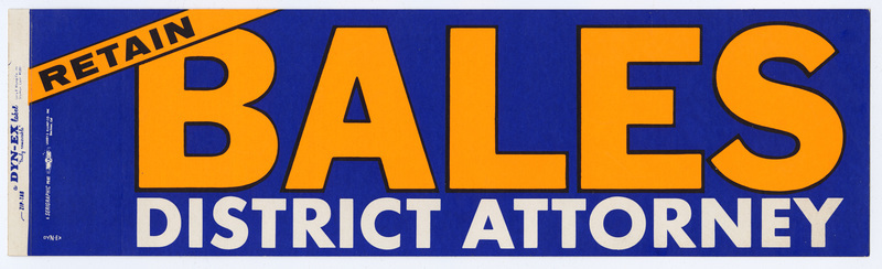 Rectangular, blue bumper sticker with yellow and white text reading "RETAIN BALES DISTRICT ATTORNEY"