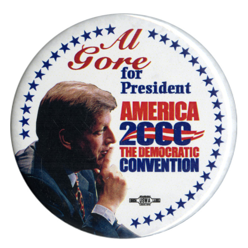Round, white button with a border of blue stars and a color photograph of Al Gore. Red and blue text reads "Al Gore for President AMERICA 2000 THE DEMOCRATIC CONVENTION"